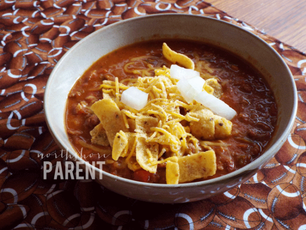 bowl of chili on football tablecloth