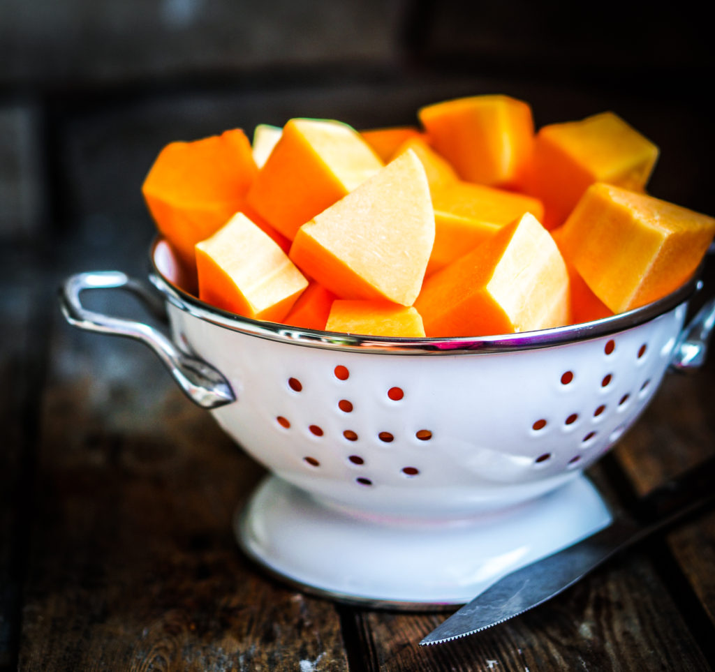 Fresh cut pumpkin on rustic wooden background