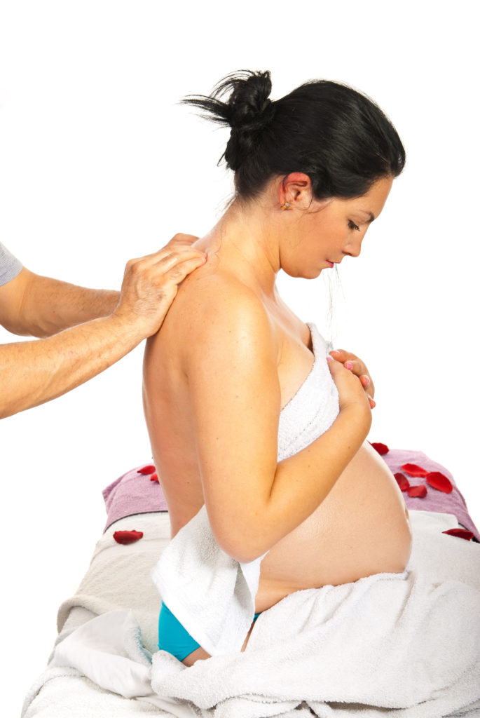 Pregnant woman receive back massage against white background