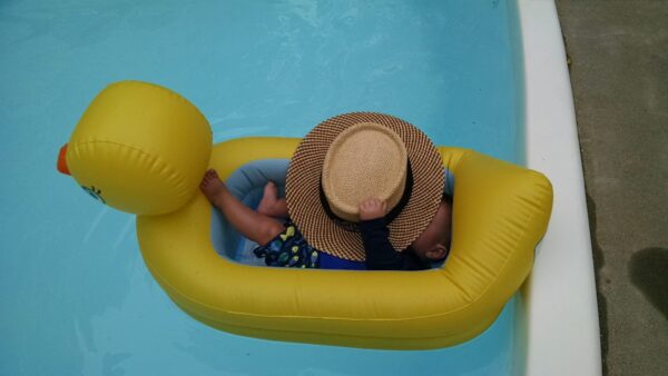 baby floats in a duck shaped pool float